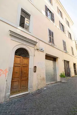 a building with a large wooden door and a garage at Le Petit Prince in Rome