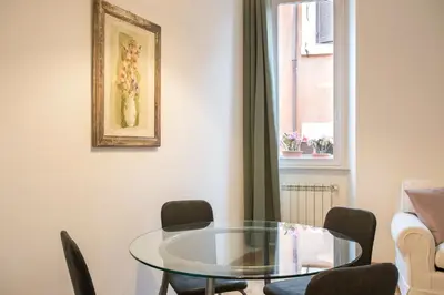 a dining room with a glass table and chairs at Eri's Apartment in Rome