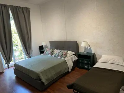 a bedroom with a bed and a window at Room Sapienza in Rome