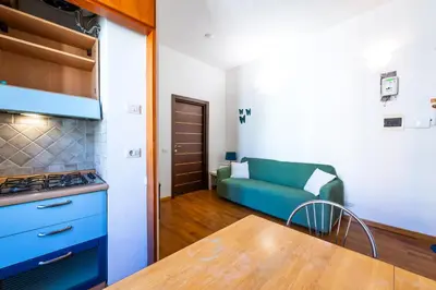 a kitchen with a blue couch in a room at Casa Nica in Rome