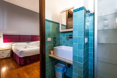 a bathroom with a tub and a bed and a mirror at Casa Nica in Rome