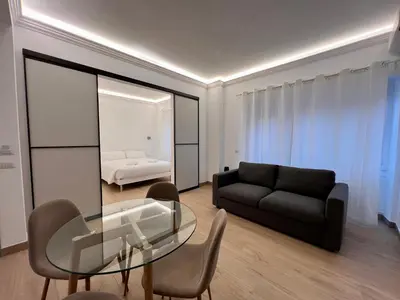 a living room with a glass table and a couch at Trastevere Tre Porte Apartments in Rome