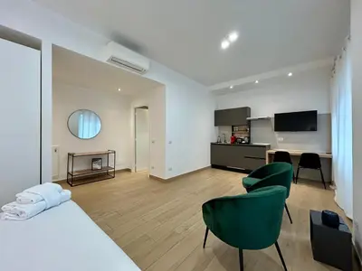 a bathroom with a walk in shower next to a glass door at Trastevere Tre Porte Apartments in Rome