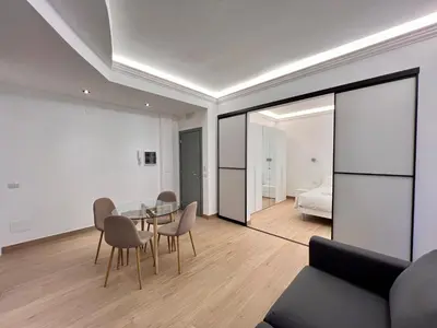 a kitchen with a counter and a table with chairs at Trastevere Tre Porte Apartments in Rome