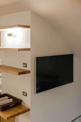 a flat screen tv on the wall of a room at Piazza Navona Luxury Loft in Rome