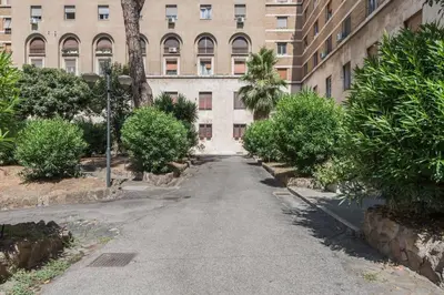 an empty street in front of a building at La Casina 348 in Rome