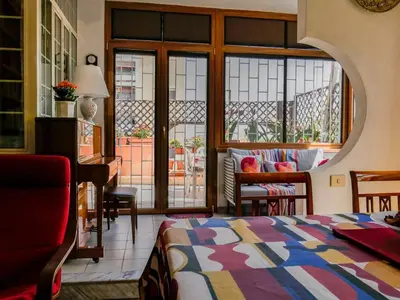 a bedroom with a bed and a room with a balcony at Chic and Spacious Rome Penthouse in Rome