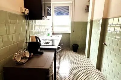 a small kitchen with a sink and a counter at 129 Gallery’s Studio @ Vatican in Rome
