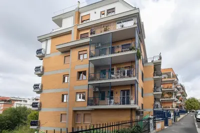 an apartment building with balconies on a street at One's Place in Rome
