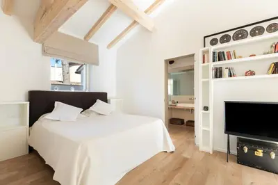 a white bedroom with a bed and a fireplace at Rome Design Villa in Rome