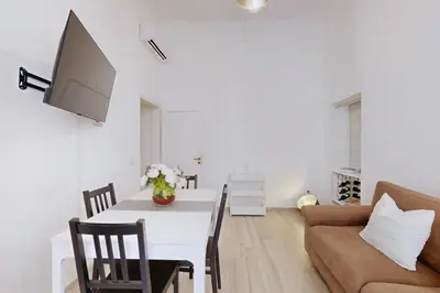 a living room with a table and a couch at Casa Vacanze BorgoVI House in Rome