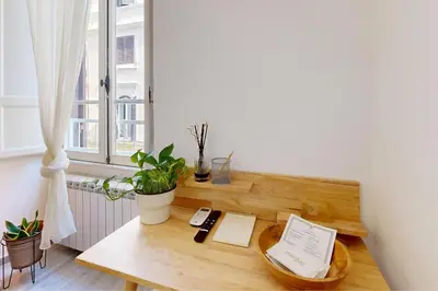 a wooden desk in a room with a window at Casa Vacanze BorgoVI House in Rome
