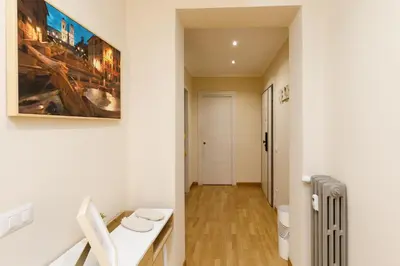 a bathroom with a toilet and a painting on the wall at Aureliana House Roma in Rome