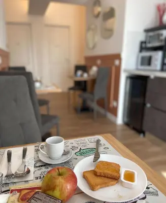 a table with a plate of breakfast food and an apple at B&B Domus Teano Luxury Rooms in Rome