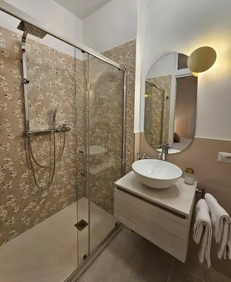 a bathroom with a sink and a shower at B&B Domus Teano Luxury Rooms in Rome