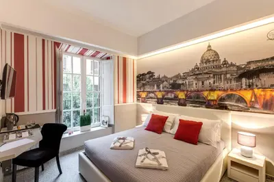 a hotel room with a bed and a desk and window at Liberty Rome Suites - Liberty Collection in Rome