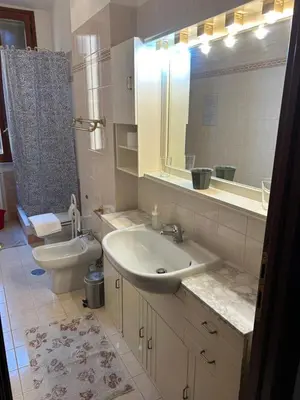 a bathroom with a sink and a toilet and a mirror at Vatican Vittoria Suite in Rome