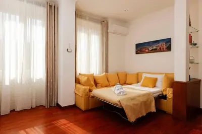 a living room with a bed and a couch at Delizioso apartment Porta Metronia Roma in Rome