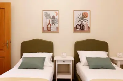 two beds sitting next to each other in a bedroom at Delizioso apartment Porta Metronia Roma in Rome