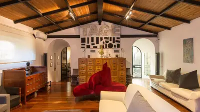 a living room with a red chair and a desk at Rental in Rome Riari Garden in Rome