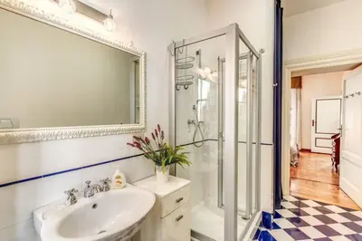 a bathroom with a sink and a shower and a mirror at XX SETT: Flat by Barberini Trevi Fountain in Rome