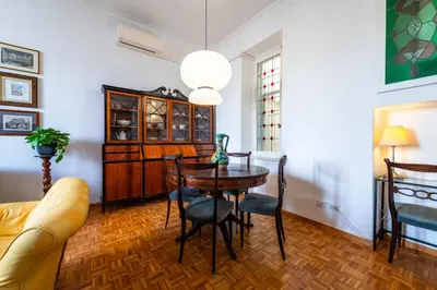 a dining room with a table and chairs at Casa Emme in Rome