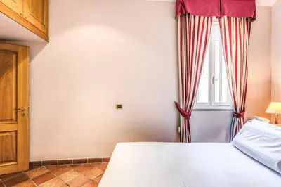 a bedroom with a bed and a window at Cozy flat in Trevi Fountain in Rome