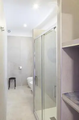 a bathroom with a glass shower and a toilet at Maria Romita in Rome
