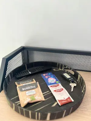 a black plastic basket with items on a table at Maria Romita in Rome