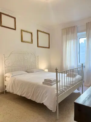 a bedroom with a white bed and a window at Maria Romita in Rome