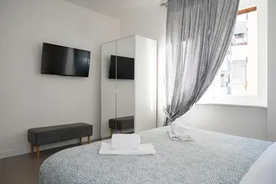 a bedroom with a bed with a mirror and a tv at St Peter Boutique 1 in Rome