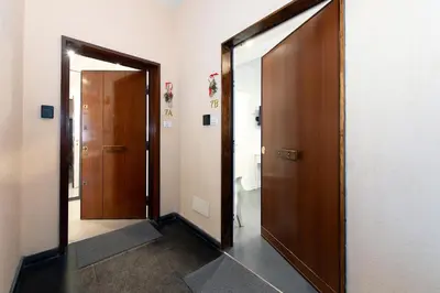 a hallway with two wooden doors in a room at St Peter Boutique 1 in Rome