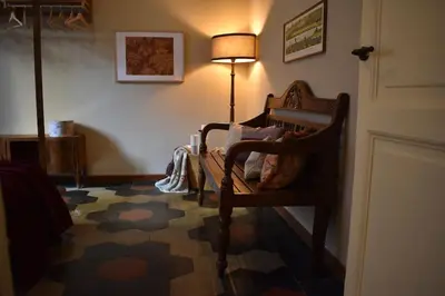 a room with a chair and a lamp on a floor at BOUTIQUE TRASTEVERE in Rome
