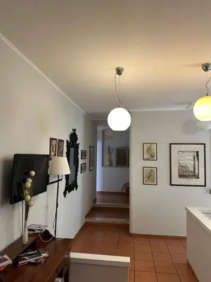 a kitchen and dining room with white walls and a table at Happy House in Piazza Zama in Rome
