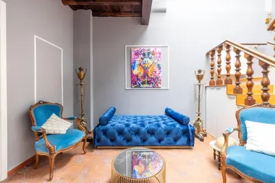 a living room with a blue couch and two chairs at maison pelliccia Terrace in Rome