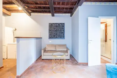 a living room with a couch and a stool at maison pelliccia Terrace in Rome