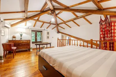 a bedroom with a large bed and a desk at Rome's Hidden Gem in Rome