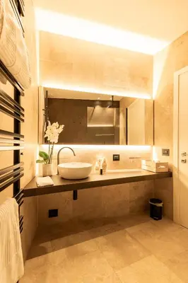 a bathroom with a sink and a large mirror at Ædrian's Loft. Boutique apartment with private terrace in the center of Rome in Rome