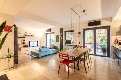 a living room with a table and chairs and a couch at Ædrian's Loft. Boutique apartment with private terrace in the center of Rome in Rome
