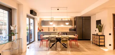 a kitchen and dining room with a table and chairs at Ædrian's Loft. Boutique apartment with private terrace in the center of Rome in Rome