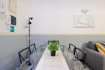 a glass table with a potted plant on it at Appartamento via di Torre Argentina (Navona) in Rome