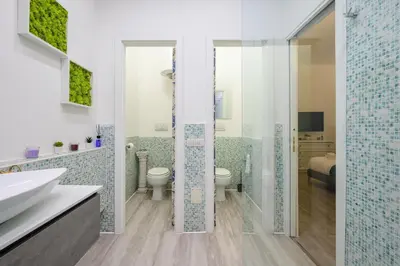 a bathroom with a shower and a toilet and a sink at Appartamento via di Torre Argentina (Navona) in Rome