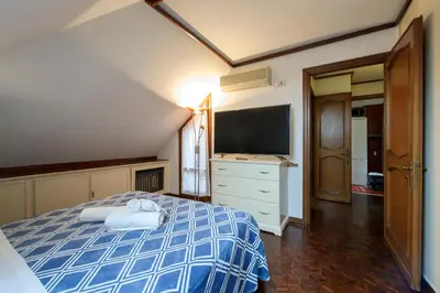 a bedroom with a bed and a television in it at Casa Justa Anastasio in Rome