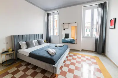 a bedroom with a large bed with a blue blanket at Vintage Giuliana Apartment in Rome