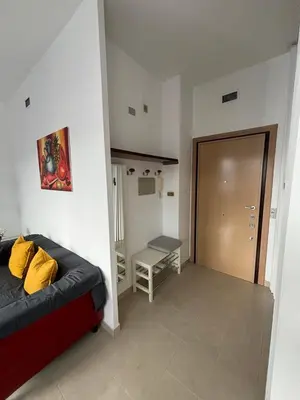 a living room with a couch and a door at Terrace Suite Roma San Giovanni in Rome