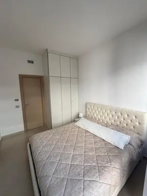 a bedroom with a large bed and a white wall at Terrace Suite Roma San Giovanni in Rome