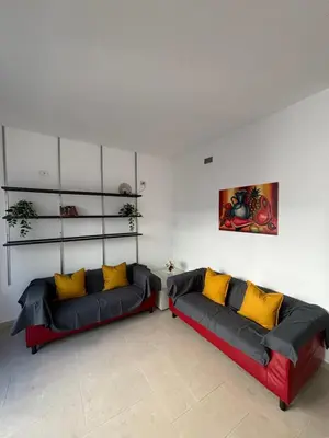 a living room with two couches with yellow pillows at Terrace Suite Roma San Giovanni in Rome