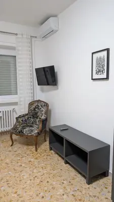a living room with a table and a chair at A casa nostra - Musei Vaticani in Rome