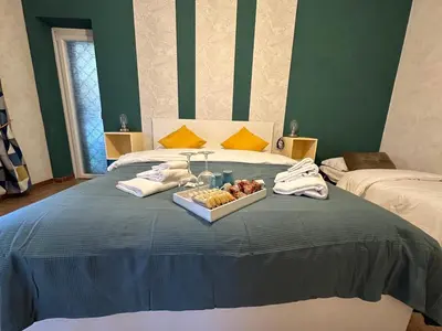 a bed with a tray of food on it at Il Giardino a Monte Sacro in Rome