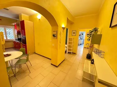 a yellow room with a table and a dining room at Il Giardino a Monte Sacro in Rome